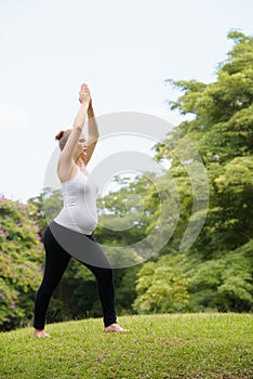 Pregnant woman mother belly relaxing park yoga meditation