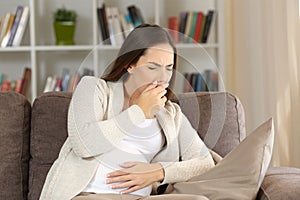 Pregnant woman with nausea at home photo