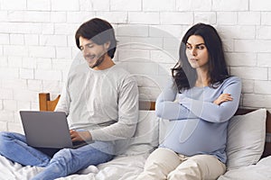 Pregnant woman offended to husband that playing games on laptop computer
