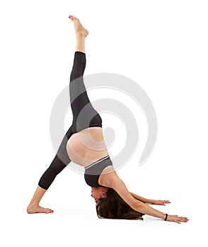 Pregnant woman in one legged downward dog pose