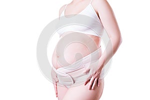 Pregnant woman with orthopedic support belt,  on white background