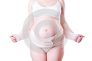 Pregnant woman with orthopedic support belt,  on white background