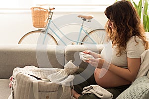 Pregnant woman packing maternity bag