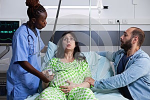 Pregnant woman in pain getting medical assistance