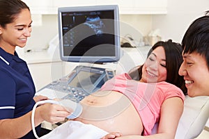 Pregnant Woman And Partner Having 4D Ultrasound Scan