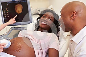 Pregnant Woman And Partner Having 4D Ultrasound Scan