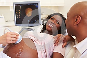 Pregnant Woman And Partner Having 4D Ultrasound Scan