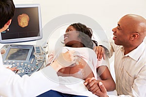 Pregnant Woman And Partner Having 4D Ultrasound Scan