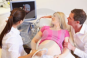 Pregnant Woman And Partner Having 4D Ultrasound Scan