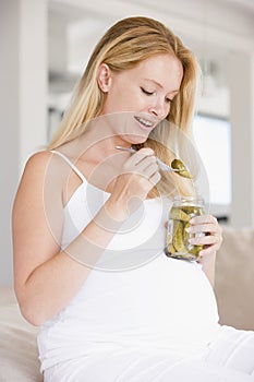 Pregnant woman with pickles smiling