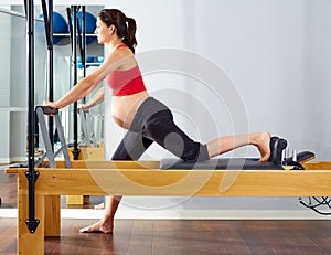 Pregnant woman pilates reformer cadillac exercise photo