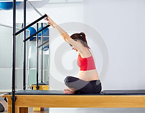 Pregnant woman pilates reformer forward push photo