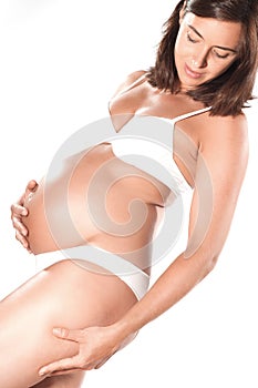 Pregnant woman pinching cellulite