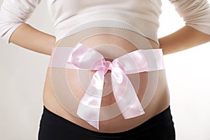 Pregnant Woman with Pink Bow Around Belly