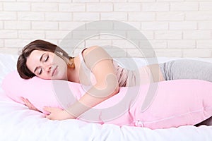 Pregnant woman with pink pillow