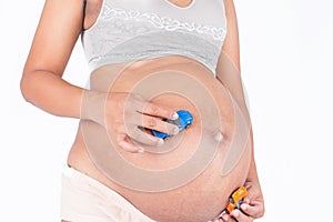 Pregnant woman play toy car