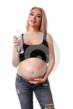Pregnant woman posing with bottle of water. Close up. White background