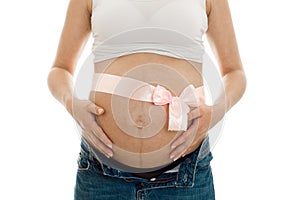 Pregnant woman posing with pink tape on her belly isolated on white background