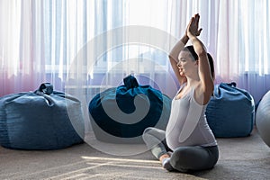 Pregnant woman practice yoga. A woman in the third trimester leads Pilates. Classes to prepare for childbirth. Waiting