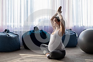 Pregnant woman practice yoga. A woman in the third trimester leads Pilates. Classes to prepare for childbirth. Waiting