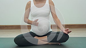 Pregnant woman practicing yoga at home. Young beautiful girl doing exercises at home. balance, meditation, relaxation, healthy lif