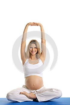 Pregnant woman practicing yoga, sitting