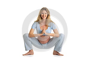 Pregnant woman practicing yoga, standing