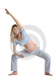 Pregnant woman practicing yoga, standing