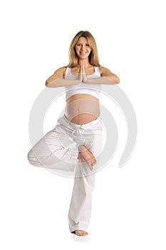 Pregnant woman practicing yoga, standing