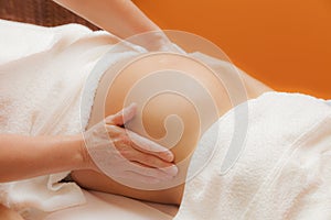 Pregnant woman at prenatal massage, glamour clarity effect