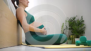 A pregnant woman is prepaexercising with breath. Concept of a healthy lifestyle during pregnancy.