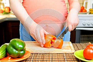 Pregnant woman preparing a healthy meal