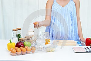 Pregnant woman preparing meal at table in the kitchen,healthy nu