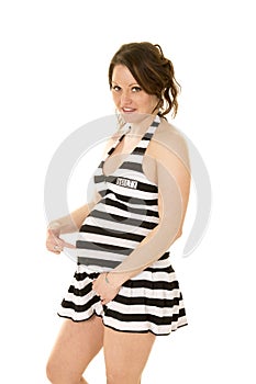 Pregnant woman in a prison skirt pointing at belly