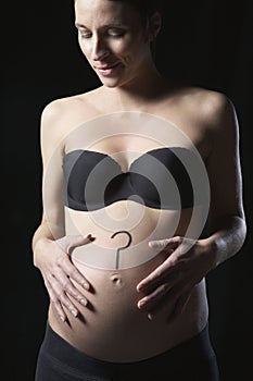 Pregnant Woman With Question Mark On Abdomen