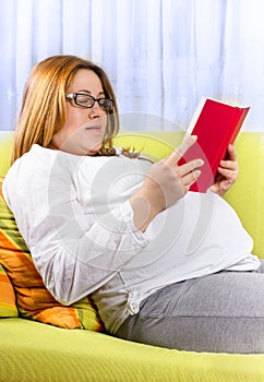 Pregnant woman reading a book