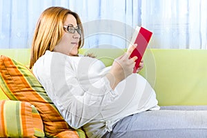 Pregnant woman reading a book