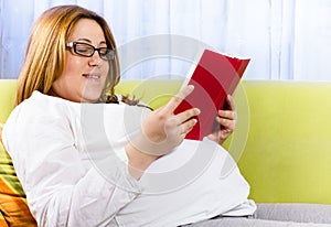 Pregnant woman reading a book