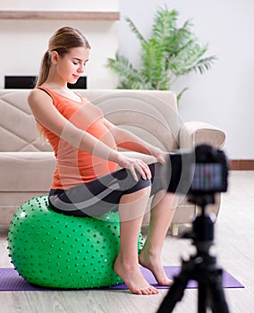 Pregnant woman recording video for blog and vlog