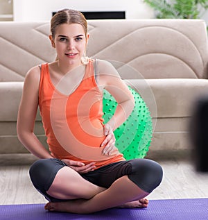 Pregnant woman recording video for blog and vlog