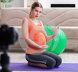 Pregnant woman recording video for blog and vlog