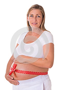 Pregnant woman with red bow around her belly