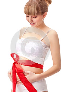 Pregnant woman with red bow on belly