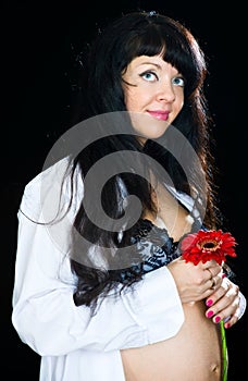 Pregnant woman with red flower