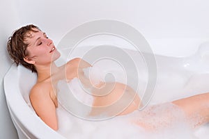 Pregnant woman is relaxing in the bath