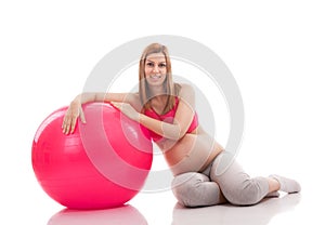 Pregnant woman relaxing after exercise with ball