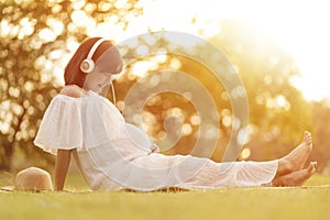 Pregnant woman Relaxing and listening music with headphones