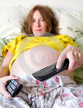 Pregnant woman with remote control