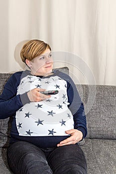 Pregnant Woman with a remote control