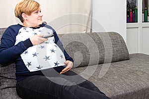 Pregnant Woman with a remote control